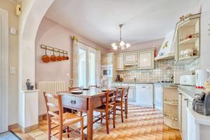a kitchen with a wooden table and chairs at Quai secret in Niversac