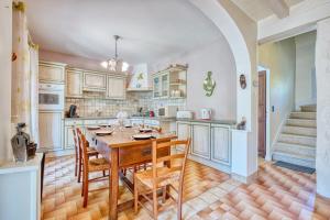 a kitchen with a wooden table and chairs at Quai secret in Niversac +35 photos