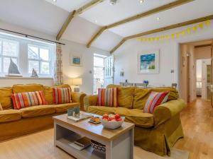 a living room with a couch and a table at 2 Bed in Wadebridge oc-82681 in Little Petherick
