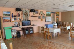 a room with a table and a television and a dining room at Magic Rock Tourist Camp in Nalayh