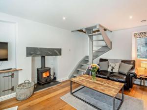 a living room with a couch and a fireplace at 1 Bed in Kendal oc-94210 in Kendal