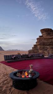 a fire pit in the middle of the desert at Silent Sands in Wadi Rum