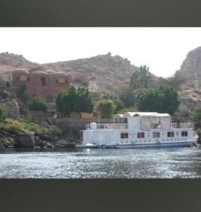 a large white boat on the water with a house at Nile Dream Yacht in Jazīrat Salūjah +8 photos