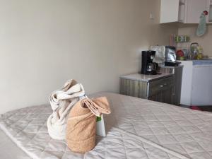 a bedroom with a bed with a towel on it at Avida Davao condo Studio type in Davao City
