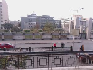 two people walking on a bridge in a city at Nour Tours in Cairo