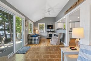 a living room with a couch and a table at Eagle's Landing Private Dock Dog Friendly in Acton