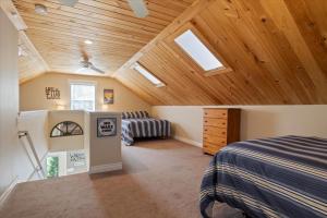 a bedroom with a bed and a ceiling with skylights at Eagle's Landing Private Dock Dog Friendly in Acton