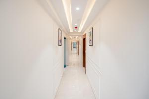 a hallway with white walls and a ceiling at Treebo Premium Bizz in Ahmedabad
