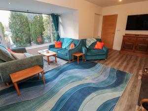 a living room with a couch and a table at Westerlodge in Keswick