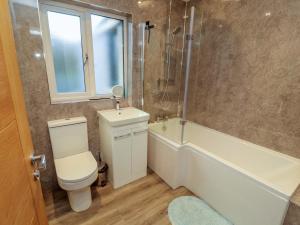 a bathroom with a toilet and a sink and a shower at Westerlodge in Keswick +33 photos