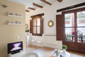 a living room with a tv and a window at Blanquerias Apartments in Valencia