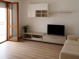 a living room with a television and a couch at Dimora del Golfo in Soverato Marina