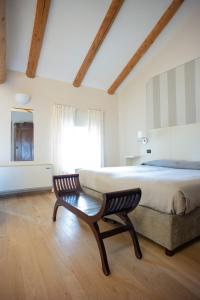 a bedroom with a bed and a chair and a window at B&B Fior Di Farine in La Morra +55 photos
