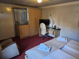 a hotel room with two beds and a desk with a computer at Hotel Rose in Weißenburg in Bayern +9 photos