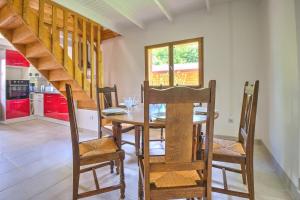 a dining room with a wooden table and chairs at Le chalet sur Manoire in Saint-Laurent-sur-Manoire +25 photos