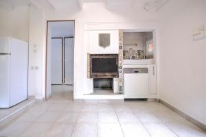 a kitchen with white walls and white appliances at Le chalet sur Manoire in Saint-Laurent-sur-Manoire
