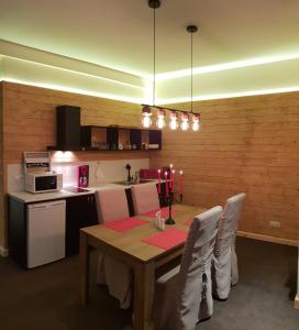 a dining room with a table and a kitchen at New Gudauri GoodHost Apartments in Gudauri +150 photos