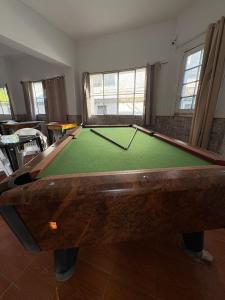 a living room with a pool table in a room at Piriápolis Hostel & suites in Piriápolis