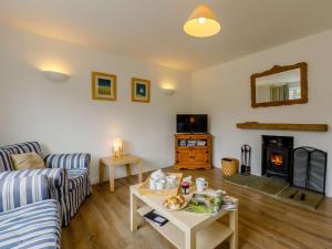 a living room with a couch and a fireplace at 3 Bed in Bridport oc-dc117 in West Bay