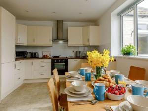 a kitchen with a wooden table with food on it at 3 Bed in Bridport oc-dc117 in West Bay