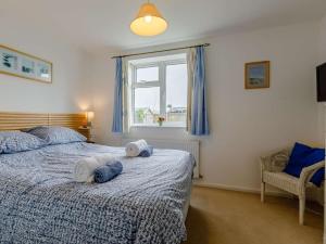 a bedroom with a bed with towels on it at 3 Bed in Bridport oc-dc117 in West Bay