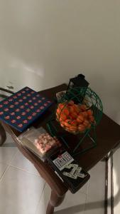 a table with a basket of oranges on it at ecopolis hospedaje birding in Papagalleros