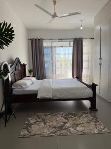 ein Schlafzimmer mit einem großen Bett und einem Fenster in der Unterkunft Etheria Haven in Mombasa + 65 Fotos