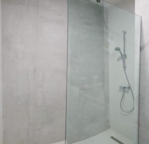 a shower with a glass door in a bathroom at New Gudauri GoodHost Apartments in Gudauri