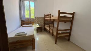 a small room with a bunk bed and a bunk ladder at Piriápolis Hostel & suites in Piriápolis +64 photos