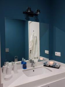a bathroom with a sink and a large mirror at New Gudauri GoodHost Apartments in Gudauri
