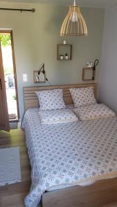 a bedroom with a large bed with two pillows at Gîte du Ka'lao in Saint-Julien