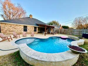 a swimming pool in the yard of a house at Keller Charm-Near Bear Creek Park & Stadiums,Pool in Keller
