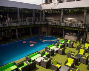 an overhead view of a swimming pool in a building at Golden Tulip Hotel in Asaba