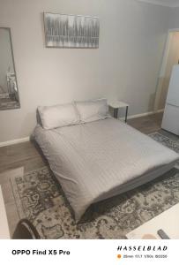 a bed in a white room with a mattress at Lovely 1 Bed apartment available in Croxley Green