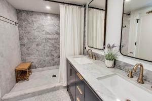 a bathroom with two sinks and a shower at Springfield Beach House in Union Pier +44 photos