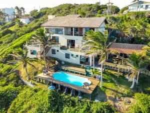 an aerial view of a house with a swimming pool at Mar Infinito Guest House in Arraial do Cabo +16 photos