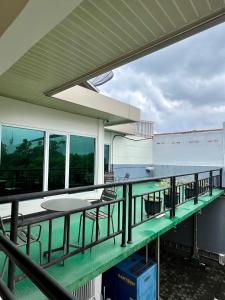 a balcony with tables and chairs and the ocean at Aurora Hotel Siliwangi in Cirebon