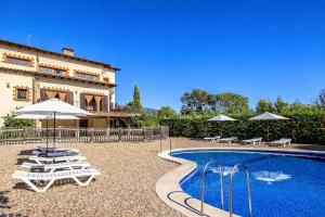 a villa with a pool and chairs and a building at Catalunya Casas Nature and Tranquility for 24 pax - 30km to beach in Sant Pere de Vilamajor