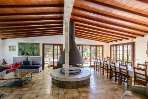 a living room with a fireplace in the middle at Catalunya Casas Nature and Tranquility for 24 pax - 30km to beach in Sant Pere de Vilamajor