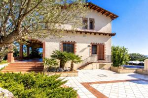 a house with a courtyard and a tree at Catalunya Casas Nature and Tranquility for 24 pax - 30km to beach in Sant Pere de Vilamajor