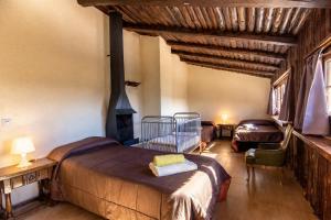 a bedroom with two beds and a fireplace at Catalunya Casas Nature and Tranquility for 24 pax - 30km to beach in Sant Pere de Vilamajor +48 photos