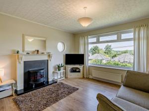 a living room with a fireplace and a television at 3 Bed in Carnforth oc-sz425 in Arnside