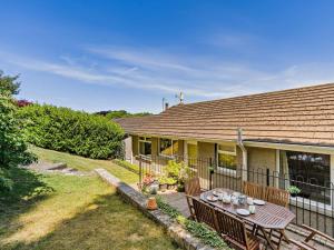 a house with a table and benches in the yard at 3 Bed in Carnforth oc-sz425 in Arnside
