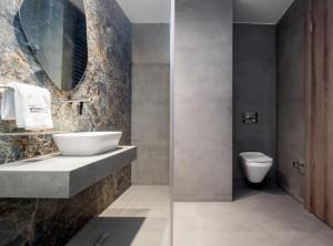 a bathroom with a sink and a toilet at Atlanticblu hotels & Resort in Abuja +27 photos