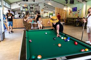 a woman playing a game of pool in a store at hu Venezia Camping in Town in Marghera