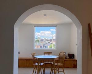 a table and chairs in a room with a window at Suncheon Stay Rev in Suncheon