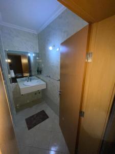 a bathroom with a sink and a mirror at Pousada do Norte, ilha do Fogo in Calheta +6 photos