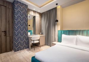 a hotel room with a bed and a desk at Atlanticblu hotels & Resort in Abuja