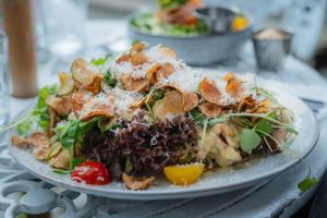 a plate of food with a salad on a table at Tre Små Rum i Trosa in Trosa