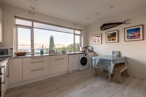 a kitchen with a table and a large window at East Vows - Elie in Earlsferry